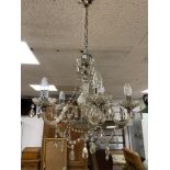 A VINTAGE CLEAR GLASS CHANDELIER WITH NUMEROUS HANGING DROPLETS
