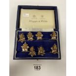 A SET OF EIGHT MAPPIN & WEBB WHITE METAL LEAF AND BERRY MENU HOLDERS IN ORIGINAL FITTED BOX