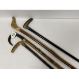 A GROUP FOUR LATE 19TH/EARLY 20TH CENTURY WALKING STICKS, INCLUDING TWO WITH SILVER COLLARS AND