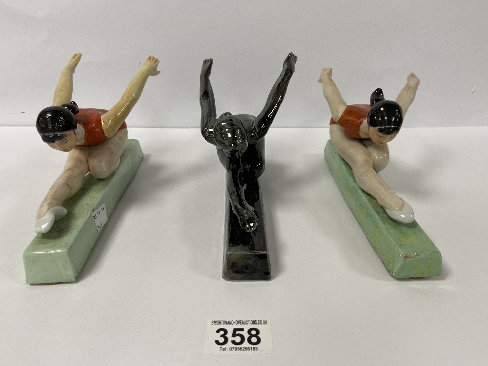 THREE CHINESE CERAMIC FIGURES OF GYMNASTS FROM THE CULTURAL REVOLUTION, 23CM WIDE