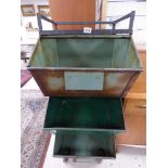 A LARGE GREEN PAINTED THREE TIER METAL STACKING SYSTEM ON CASTORS