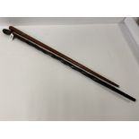 AN UNUSUAL ASH WALKING STICK OF GRADUATING FORM WITH APPLIED WHITE METAL PLAQUE, SIMILAR IN SHAPE TO