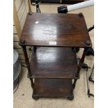 A THREE TIER ROSEWOOD TABLE ON ORIGINAL CASTORS