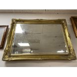 A LARGE MODERN GILDED WALL MIRROR OF RECTANGULAR FORM, 90CM BY 65CM