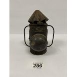 A SMALL EARLY METAL CANDLELIT RAILWAY LAMP WITH DOMED GLASS FRONT, 16.5CM HIGH