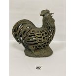 A CAST METAL FIGURE OF A COCKERAL WITH PIERCED DECORATION, 30CM HIGH