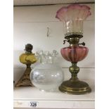 TWO EARLY 20TH CENTURY BRASS AND GLASS OIL LAMPS, ONE BY DUPLEX MADE IN ENGLAND, LARGEST 46CM HIGH