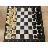 AN UNUSUALLY LARGE CHESS SET WITH FOLD OUT BOARD, LARGEST PIECES APPROX 19CM HIGH