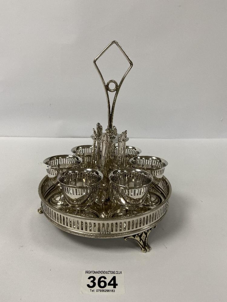 A VINTAGE SILVER PLATED SIX PIECE EGG CUP AND SPOON SET MOUNTED UPON FITTED TRAY OF CIRCULAR FORM,