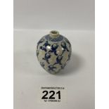 AN EARLY CHINESE POTTERY SPILL VASE OF OVOID FORM, DECORATED THROUGHOUT IN BLUE AND WHITE WITH