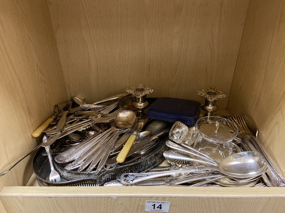 A COLLECTION OF SILVER PLATED WARES, INCLUDING TWO SERVING TRAYS, FLATWARE, A PAIR OF CANDLESTICKS
