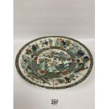 A 19TH CENTURY CHINESE FAMILLE VERTE CHARGER DECORATED THROUGHOUT IN THE KANGXI STYLE, THE CENTRAL