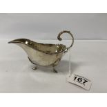 A SILVER SAUCEBOAT WITH BEADED BORDER, RAISED UPON THREE HOOF FEAT, HALLMARKED BIRMINGHAM 1919 BY