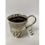 A LATE VICTORIAN SILVER CIRCULAR CHRISTENING MUG WITH EMBOSSED DECORATION THROUGHOUT, HALLMARKED