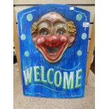A WEILOMS SIGN WITH A CARVIN OF A CLOWN 44 X 62 CMS