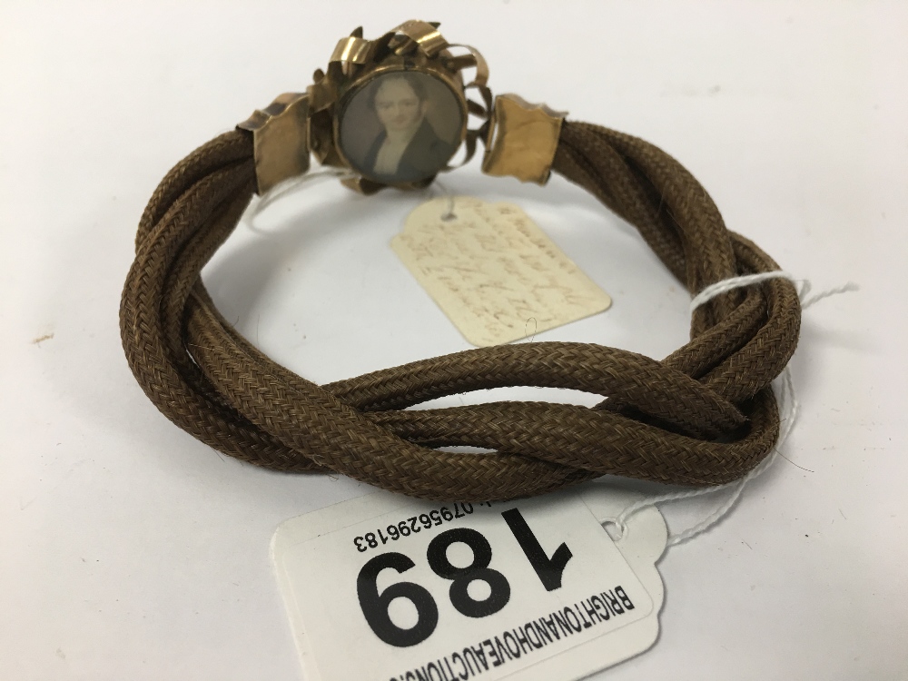 A LATE 19TH CENTURY YELLOW METAL AND FABRIC BRACELET WITH TWO OVAL PICTURE MOMENTO'S, ONE ON EACH - Image 2 of 2