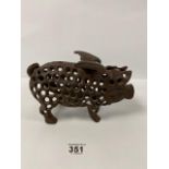 A CAST IRON FIGURE OF A FLYING PIG WITH PIERCED DETAILING THROUGHOUT, 25CM WIDE