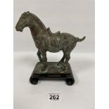 A CHINESE BRONZE FIGURE OF A HORSE, CHARACTER MARK TO THE BASE, RAISED UPON A WOODEN BASE WITH