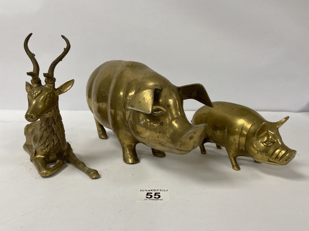 A LARGE BRASS FIGURE OF A PIG, 36CM LONG, TOGETHER WITH A SMALLER SIMILAR BRASS PIG AND A DEER