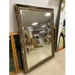 A BEVELLED EDGED MIRROR 71 x 100 CMS