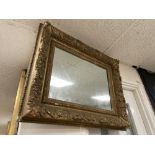 A HEAVY ANTIQUE GILT GESSO FRAMED MIRROR, 86CM BY 69CM