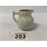 AN EARLY BOW PORCELAIN WHITE GLAZED CREAM JUG WITH MOLDED FLORAL SPRAY AND BUTTERFLY MOTIFS, 6CM