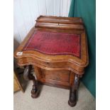 A VICTORIAN WALNUT SERPENTINE FRONT DAVENPORT ON ORIGINAL CASTORS