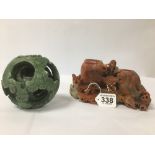 TWO ORIENTAL CARVED SOAPSTONE ITEMS, INCLUDING A STYLISED TWO HOLE VASE AND GRADUATING PIERCED BALL
