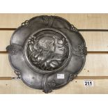 AN ART NOUVEAU PEWTER HANGING WALL PLATE SHOWING A STYLISED GIRL AMONGST FLOWERS, 30.5CM DIAMETER (