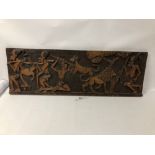 AN AUTHENTIC AFRICAN CARVED WOODEN PANEL WITH DETAIL OF HUNTERS AND GAME, 93CM BY 31CM, FROM A