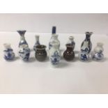 A COLLECTION OF ASSORTED SMALL ORIENTAL PORCELAIN VASES, MOST BEING BLUE AND WHITE IN COLOUR,