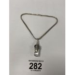 AN UNUSUAL 925 SILVER DOGS HEAD WHISTLE PENDANT ON AN ITALIAN SILVER CHAIN, 31G