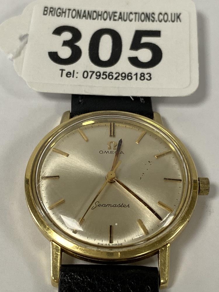 A VINTAGE GOLD CASED OMEGA SEAMASTER GENTS WRISTWATCH, THE SILVERED DIAL WITH BATONS DENOTING HOURS,