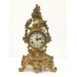 A VINTAGE GILT METAL MANTLE CLOCK IN THE ROCOCO STYLE BY WALT, THE ENAMEL DIAL WITH ROMAN NUMERALS