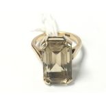 A 9CT GOLD SET WITH A LARGE SMOKEY QUARTZ OF RECTANGULAR FORM, RING SIZE J, 5.8G