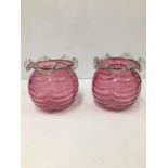 A PAIR OF CRANBERRY GLASS VASES OF GLOBULAR FORM WITH FLUTED RIMS, 15CM HIGH