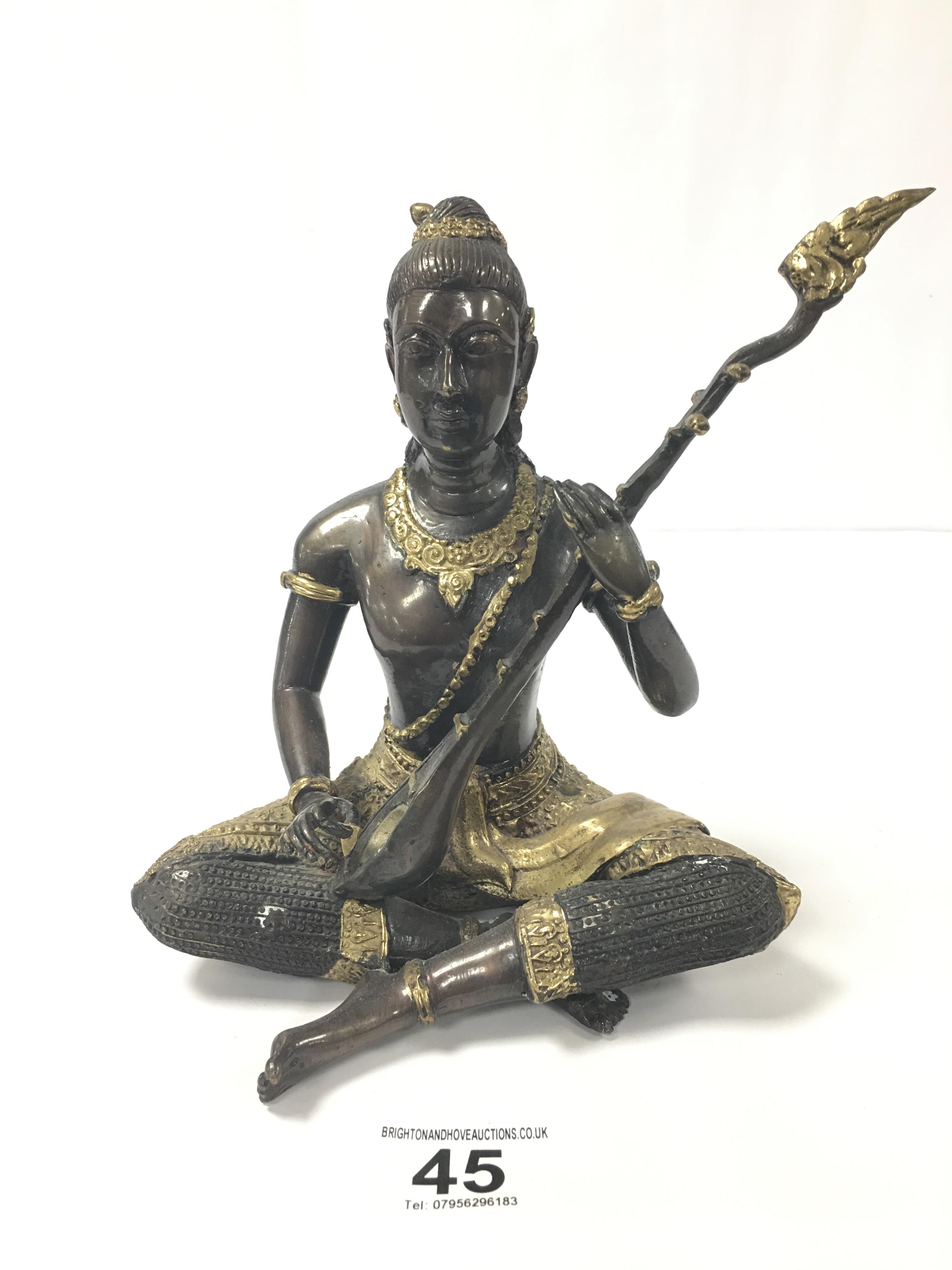 A BRONZE FIGURE OF A HINDU DEITY WITH GILT DETAILING THROUGHOUT, 19CM HIGH