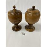 PRIVATE COLLECTION: A PAIR OF VINTAGE AFRICAN TURNED WOODEN LIDDED POTS ON A PEDESTAL BASE, 21CM