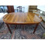 A MODERN ROSEWOOD DINING TABLE WITH ADDITIONAL LEAVES