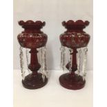 A PAIR OF VICTORIAN CRANBERRY GLASS LUSTRES WITH HANGING GLASS DROPLETS, THE TOP HALF WITH HAND