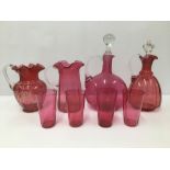 A COLLECTION OF CRANBERRY GLASS ITEMS, INCLUDING TWO DECANTERS OF GLOBULAR FORM WITH STOPPERS,