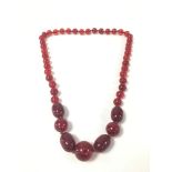 A VINTAGE CHERRY AMBER/BAKELITE BEAD NECKLACE, 105G