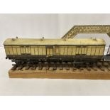 AN EARLY 20TH CENTURY LMC LEEDS MODEL COMPANY O GAUGE RAILWAY CARRIAGE, L & NWR, C.1920'S, MOUNTED