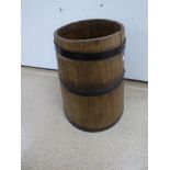 A LARGE FRENCH OAK BARREL WITH METAL BANDING.