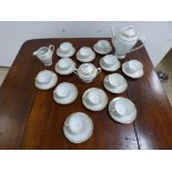 AN EXTENSIVE FRENCH PORCELAIN TEA SET BY 'DE SOLOGNE LARCHEVEQUE' INCLUDING TEA POTS, CUPS,