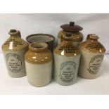 A GROUP OF SIX STONEWARE STORAGE VESSELS, INCLUDING THREE MACKINTOSH BROS LTD GINGER BEER FROM THE