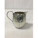 A VICTORIAN SILVER HALF FLUTED ENGRAVED CREAM JUG, HALLMARKED BIRMINGHAM 1889 BY HILLIARD AND