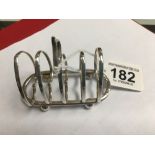 A SMALL SILVER FOUR SLICE TOAST RACK, HALLMARKED BIRMINGHAM 1912 BY BOOTS PURE DRUG CO, 8.5CM