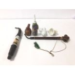 A GROUP OF EARLY PIPES, INCLUDING 19TH CENTURY GERMAN CERAMIC EXAMPLE AND MORE