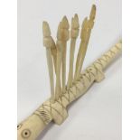 A NOVELTY CARVED IVORY FIGURE OF A CROCODILE WITH EIGHT SPEAR SHAPED COCKTAIL STICKS, 24.5CM LONG